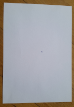 One black dot in the middle of the page